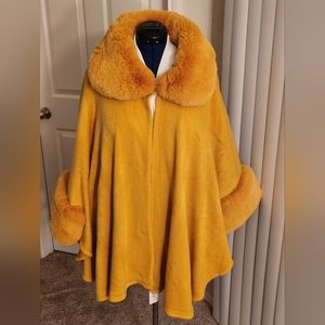 Mustard gold sweater cape with faux fur collar and cuffs.  One size fits most.